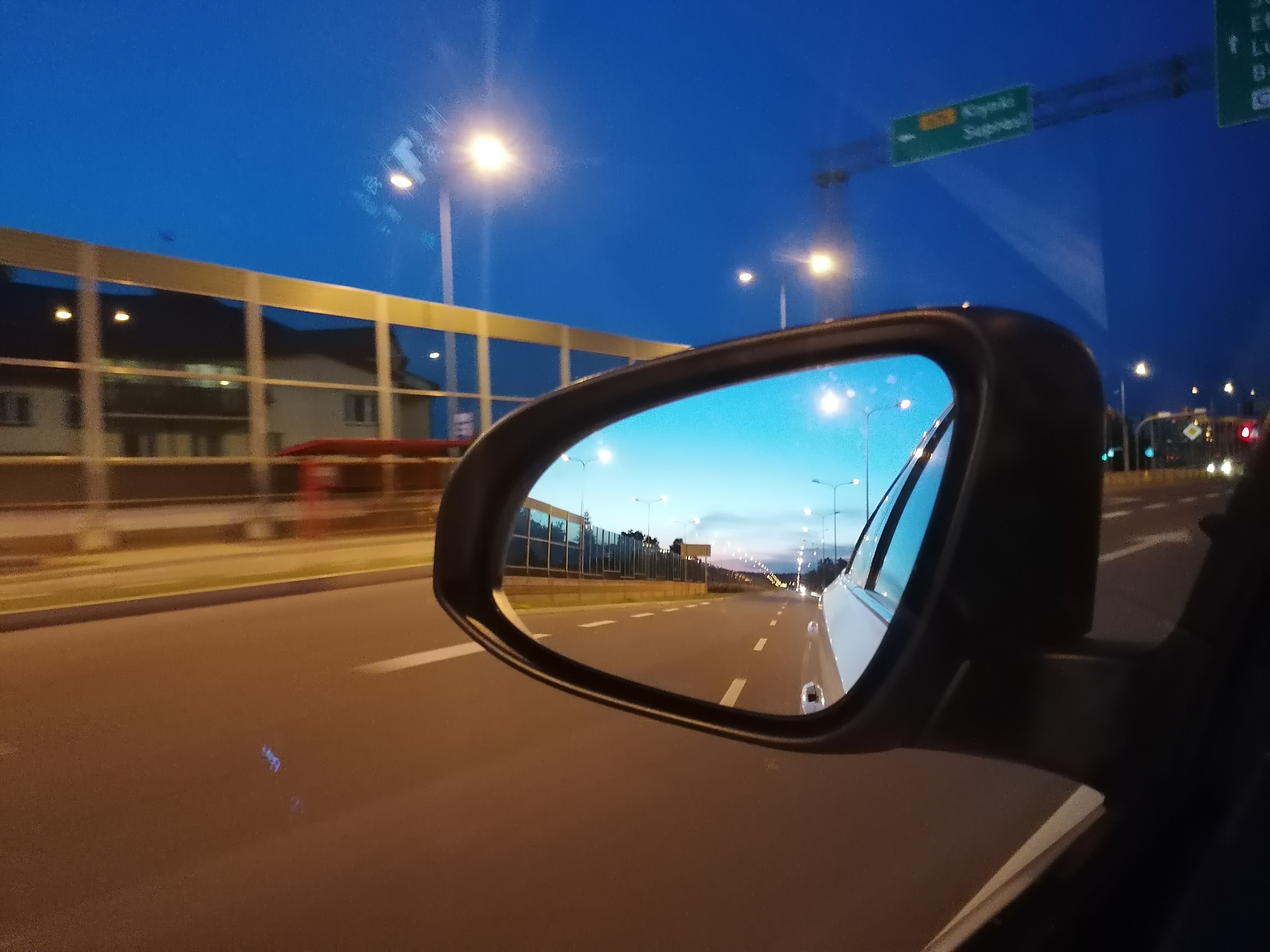 Lusterko samochodu jadącego nocą przez miasto