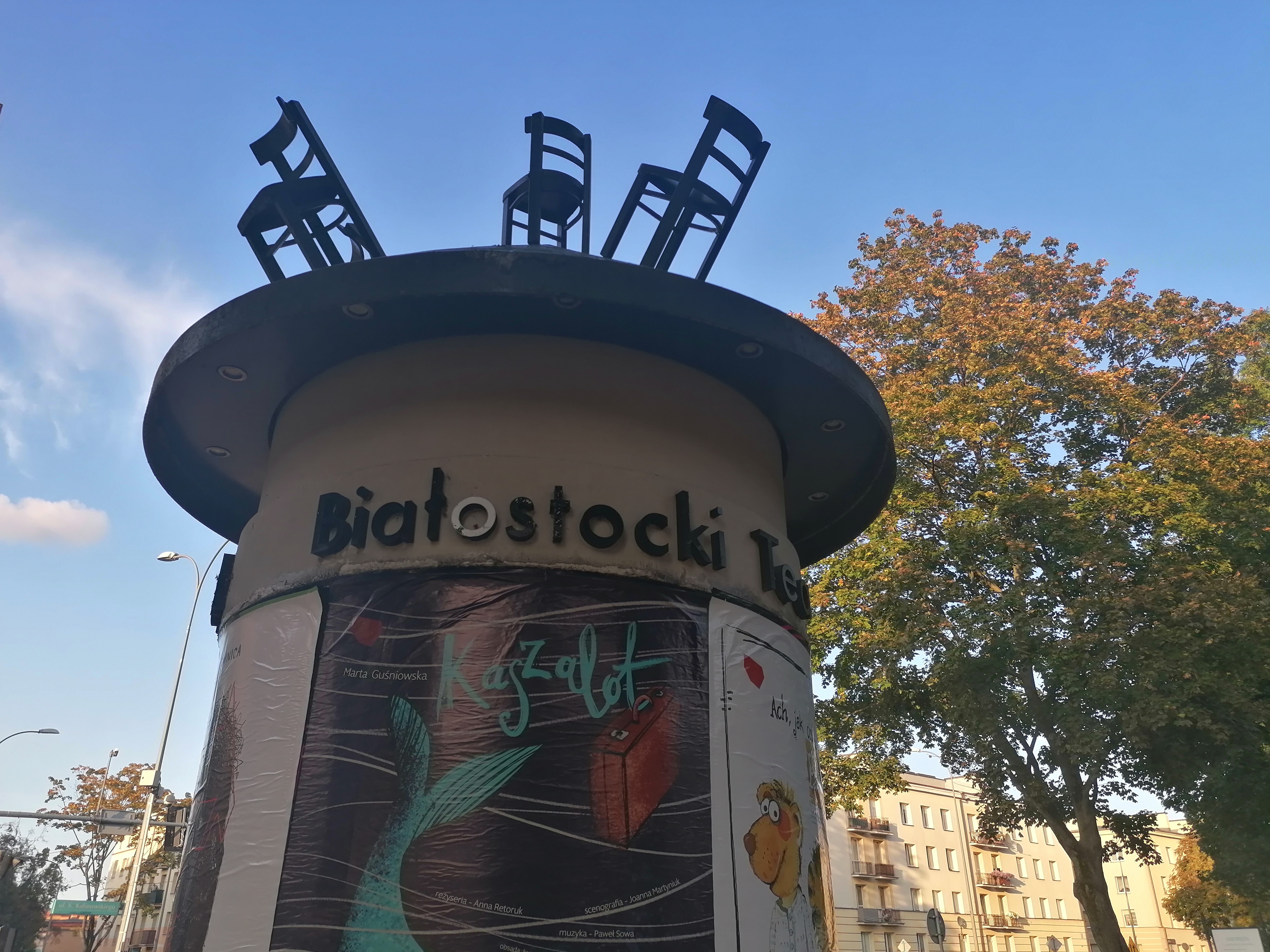 Słup ogłoszeniowy, na którym rozwieszone są plakaty promujące spektakle Białostockiego Teatru Lalek