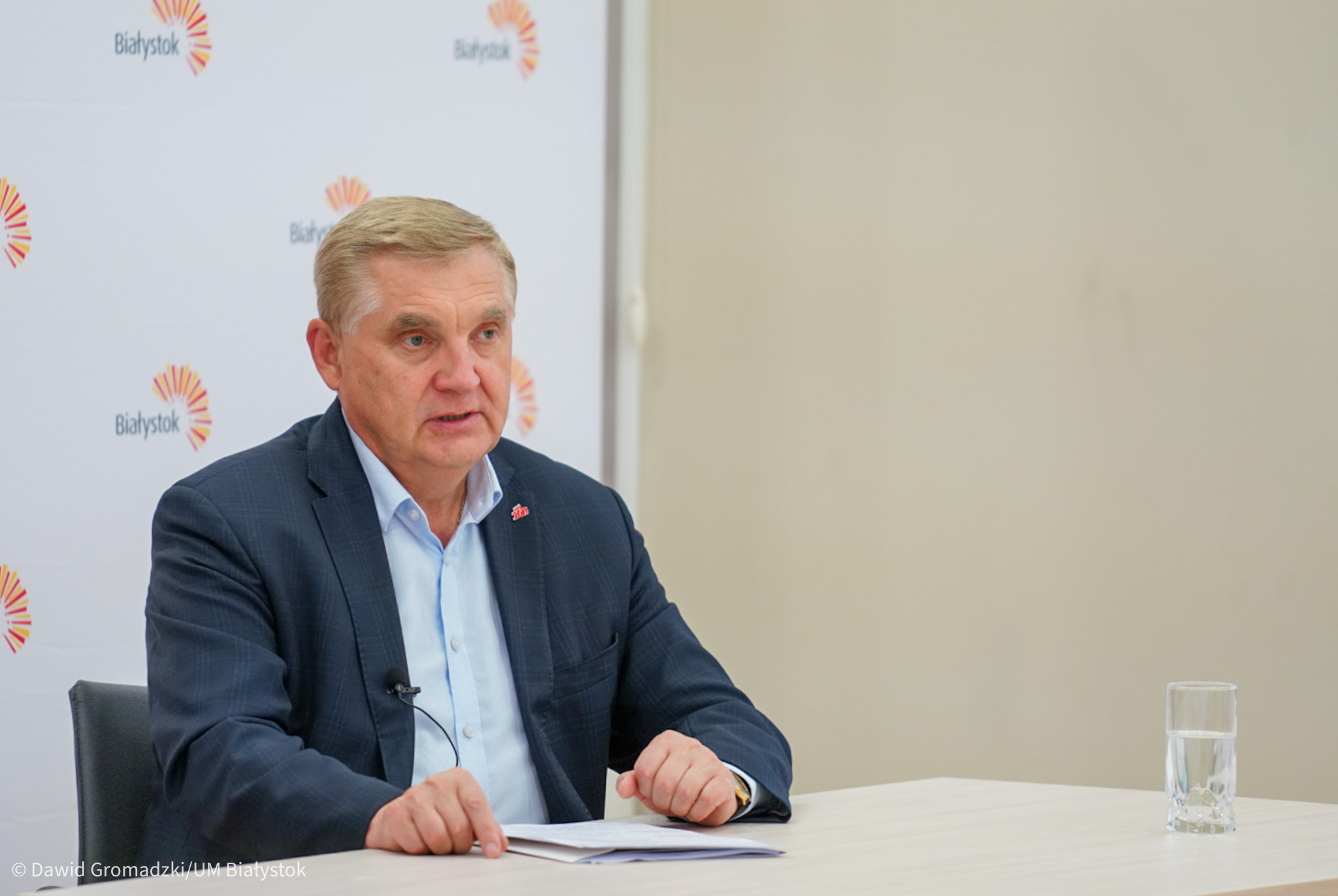 Prezydent Białegostoku siedzi przy stole.