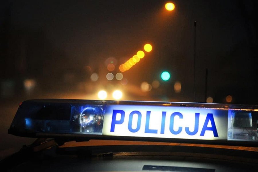 Dach oznakowanego radiowozu. W tle światła pojazdu