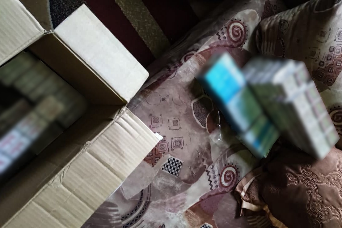 Papierosy w kartonie i na łóżku