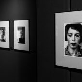 Czarno-białe fotografie w antyramach na ścianie muzeum