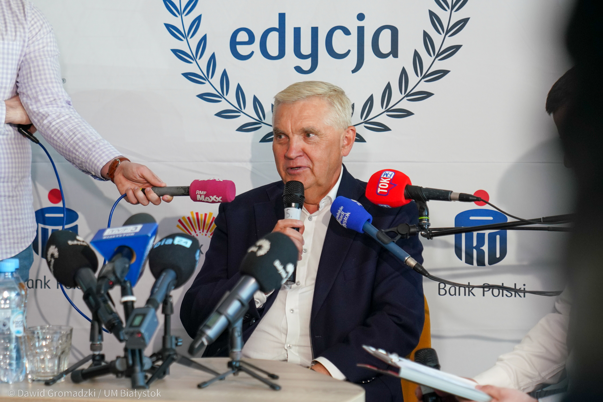 Mężczyzna przed mikrofonami.