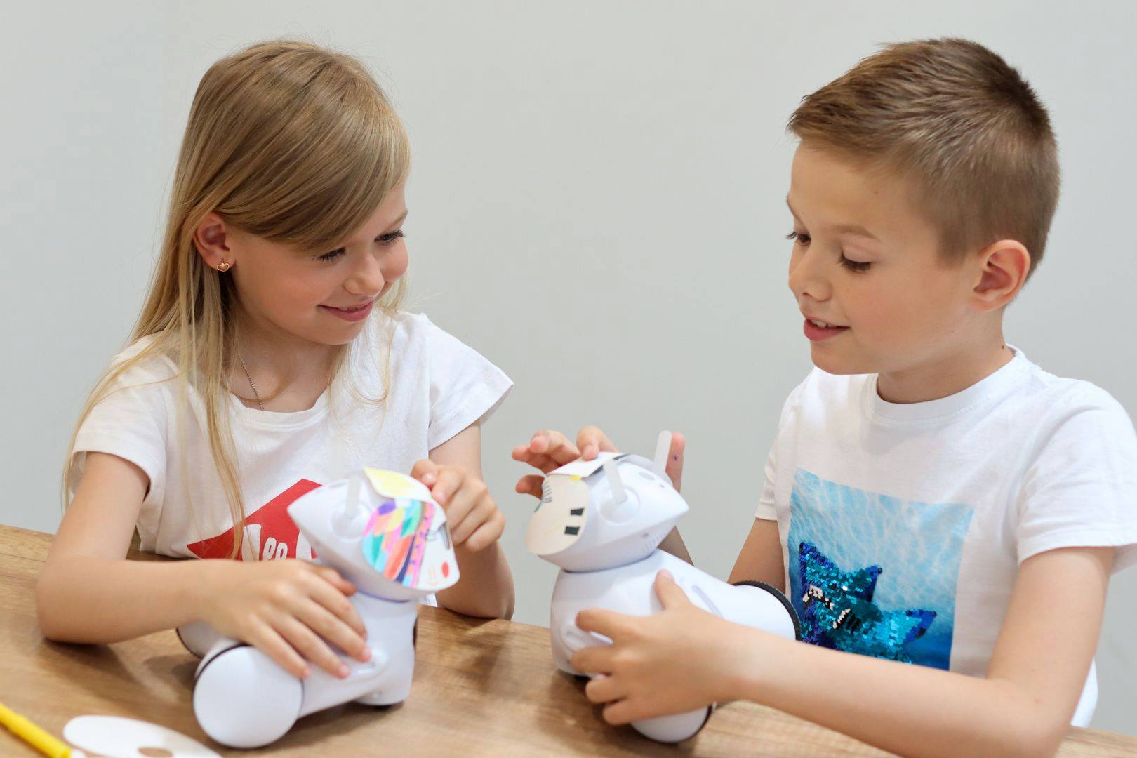 Dziewczynka i Chłopiec trzymają roboty edukacyjne